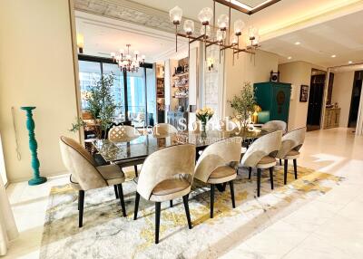 Elegant dining area with large table and modern chandelier