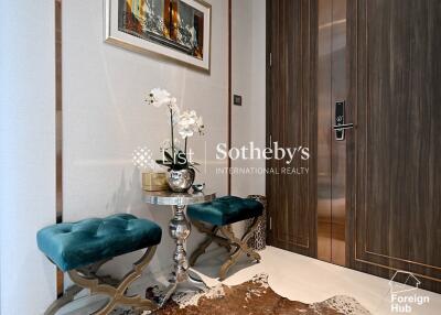 Elegant entryway with teal seating and decor