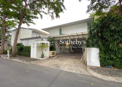 Modern house exterior with driveway and greenery