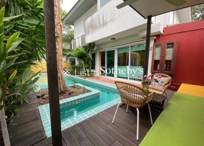 Outdoor patio with pool and seating area