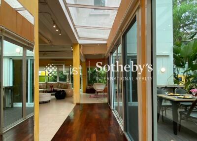 Spacious hallway with hardwood flooring and glass ceiling