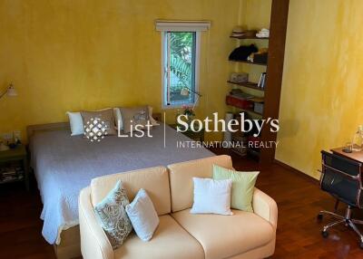 Spacious bedroom with seating area and desk