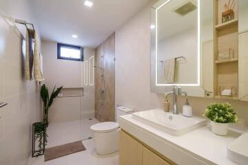 Modern bathroom with large mirror and glass-enclosed shower