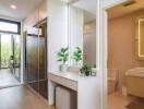 Modern dressing room with full-length mirrors and bathroom