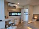 Modern bedroom with desk, air conditioner, and platform bed