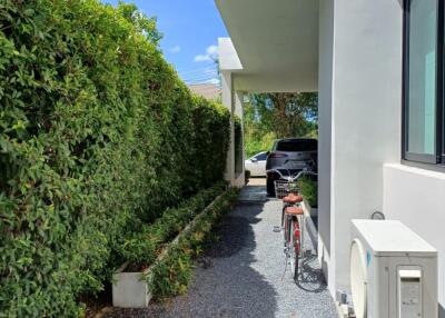 Outdoor driveway area with a bicycle and car