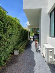 Outdoor driveway area with a bicycle and car