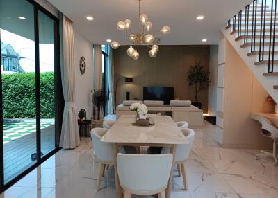 Modern living and dining area with chandelier