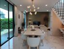 Modern living and dining area with chandelier