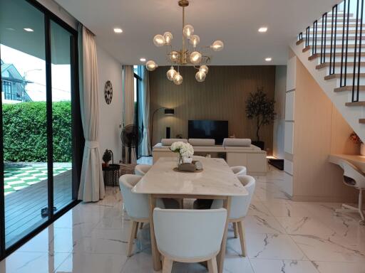 Modern living and dining area with chandelier