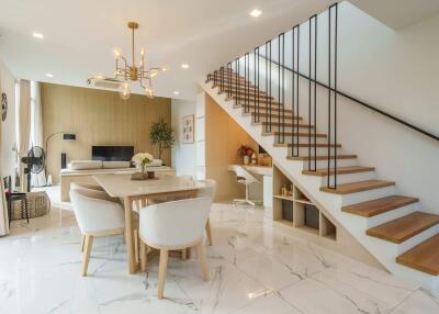 Modern living and dining area with staircase