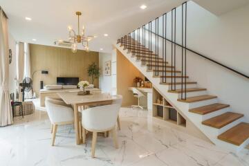 Modern living and dining area with staircase