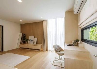 Well-lit modern bedroom with work desk and large window