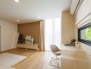 Well-lit modern bedroom with work desk and large window