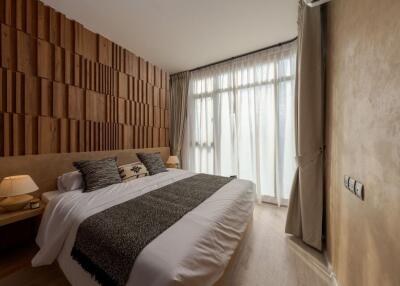 Modern bedroom with wooden accent wall and large window