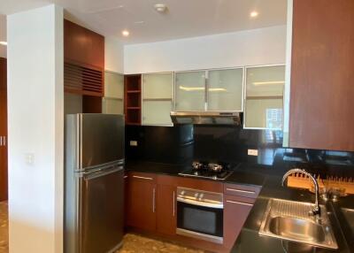 Modern kitchen with stainless steel appliances and dark wood cabinetry