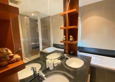 Modern bathroom with double sinks and a walk-in shower