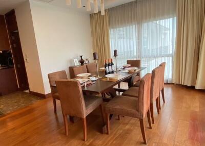 Dining room with a large wooden table set for eight