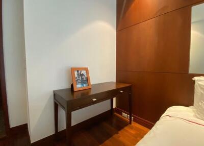 Minimalist bedroom corner with desk and framed photo