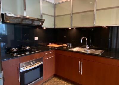 Modern kitchen with stainless steel appliances and black countertops