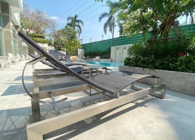 Outdoor pool area with lounge chairs