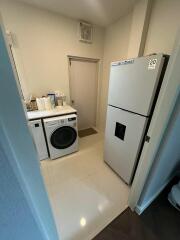 Laundry room with washer, dryer, and refrigerator