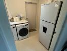 Laundry room with washer, dryer, and refrigerator