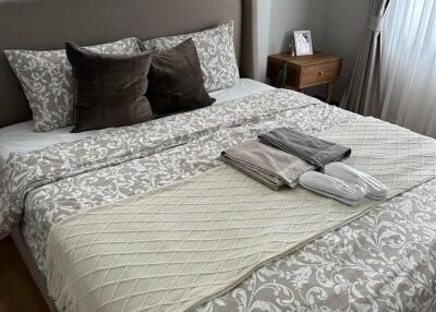 Well-decorated and cozy bedroom with a neatly made bed and stylish bedding.