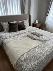 Well-decorated and cozy bedroom with a neatly made bed and stylish bedding.