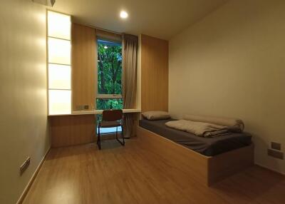 Minimalist bedroom with single bed and study area