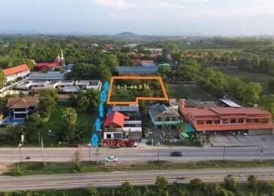 Aerial view of a land plot marked for sale in a residential area