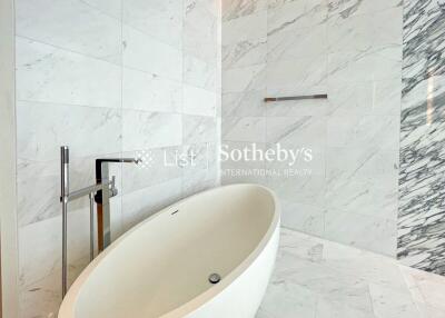 Modern bathroom with marble tiles and freestanding bathtub