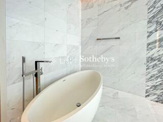 Modern bathroom with marble tiles and freestanding bathtub