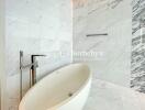 Modern bathroom with marble tiles and freestanding bathtub