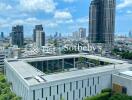 Aerial view of a modern cityscape with high-rise buildings and lush greenery.