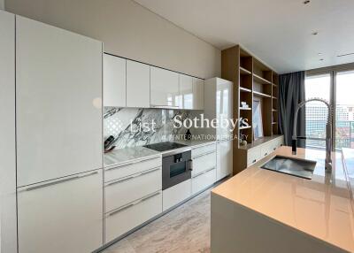 Modern kitchen with sleek white cabinetry and marble backsplash