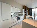 Modern kitchen with sleek white cabinetry and marble backsplash