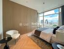 Modern bedroom with large windows offering city views