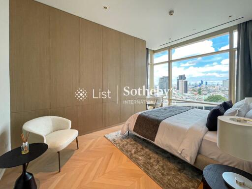 Modern bedroom with large windows offering city views