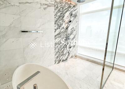 Modern bathroom with marble tiles and a freestanding bathtub