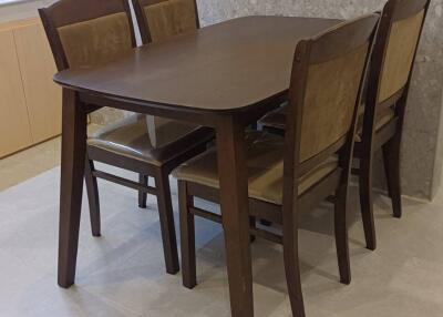 Dining area with wooden table and four chairs