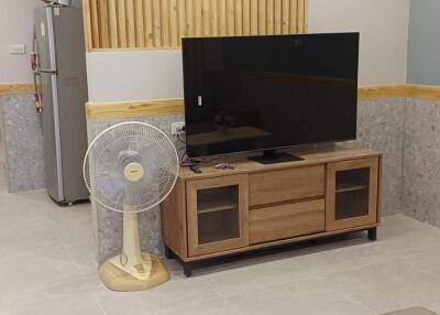 Living room area with TV and staircase