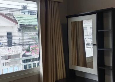 Bedroom with window, air conditioner, and mirror desk