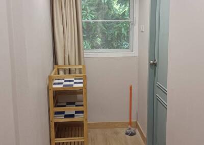 Small utility room with window and cleaning supplies