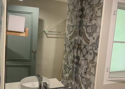 modern bathroom with patterned tiles and circular sink