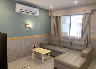 Living room with air conditioner and corner sofa