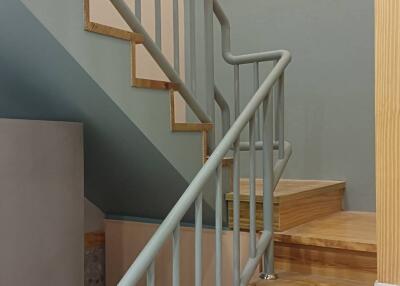 Wooden staircase with painted metal railings