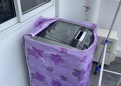 A protected washing machine in a covered laundry area