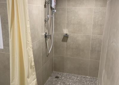 Shower area with tiled walls and floor