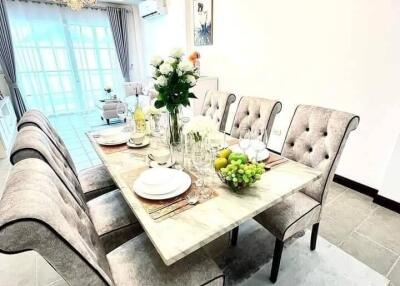 Elegant dining area with plush chairs and a well-set table